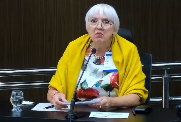 Deputada alemã está sentada falando ao microfone