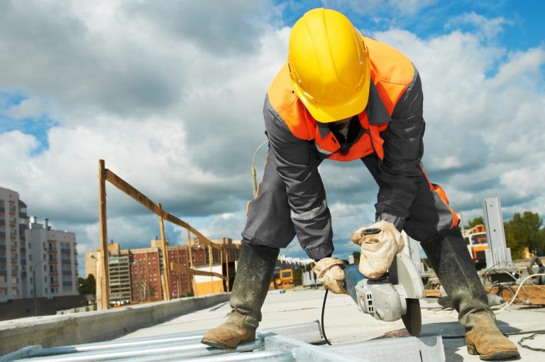 Operário trabalha em construção de prédio num dia ensolarado